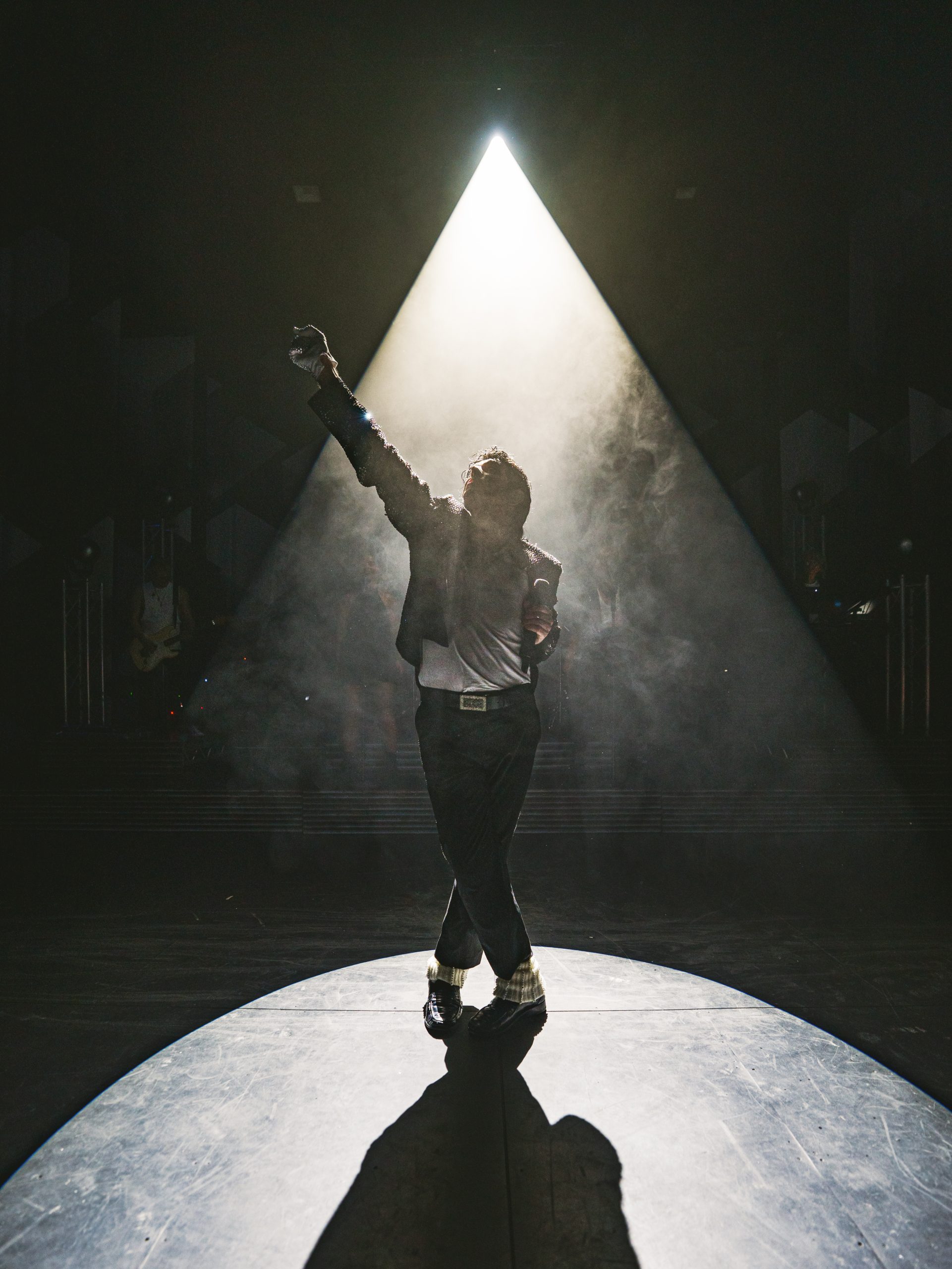 A lone performer caught in a single shaft of light