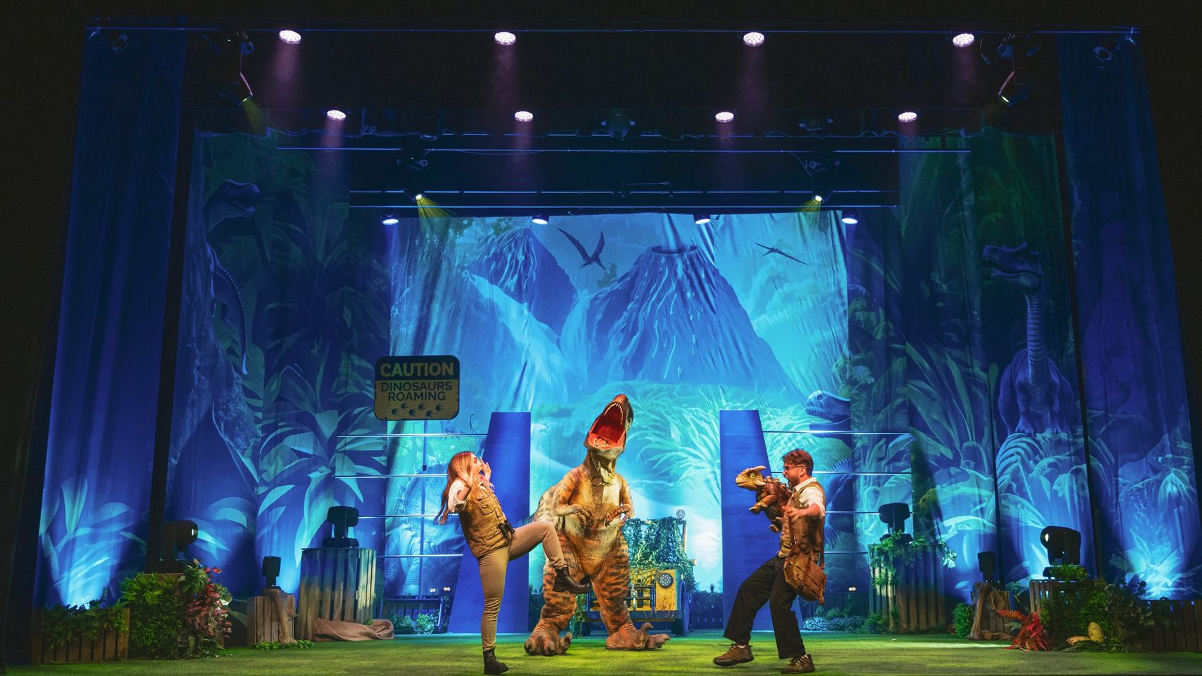 Dino Tales — family show with walking dinosaurs in jungle lighting